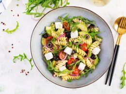 Pasta salad with tomato, avocado, black olives, red onions and cheese feta.