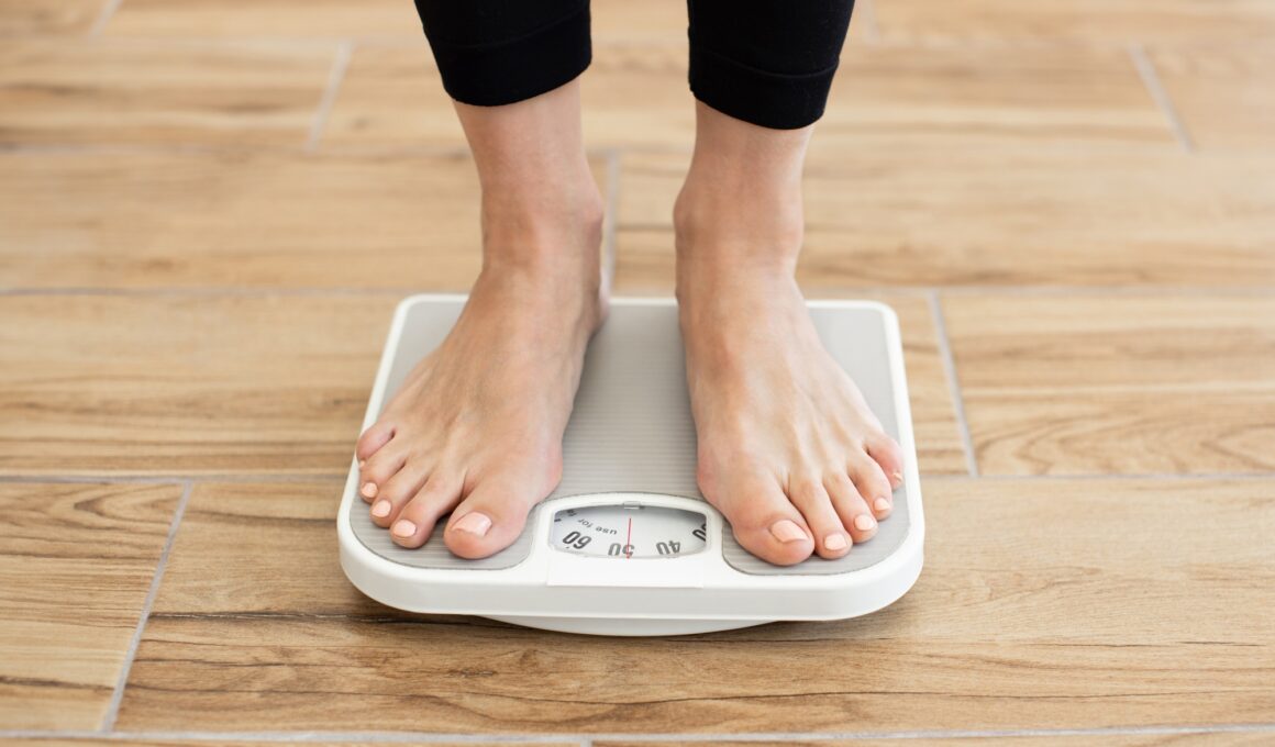 Person standing on scale checking body weight in gym