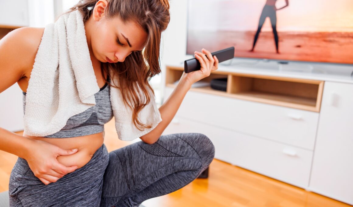 Woman holding belly fat worried while doing home workout