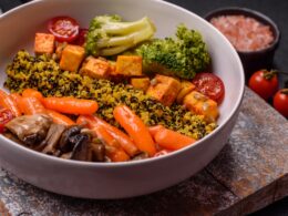 Colorful vegan vegetarian dish consists of tofu, broccoli, quinoa, mushrooms