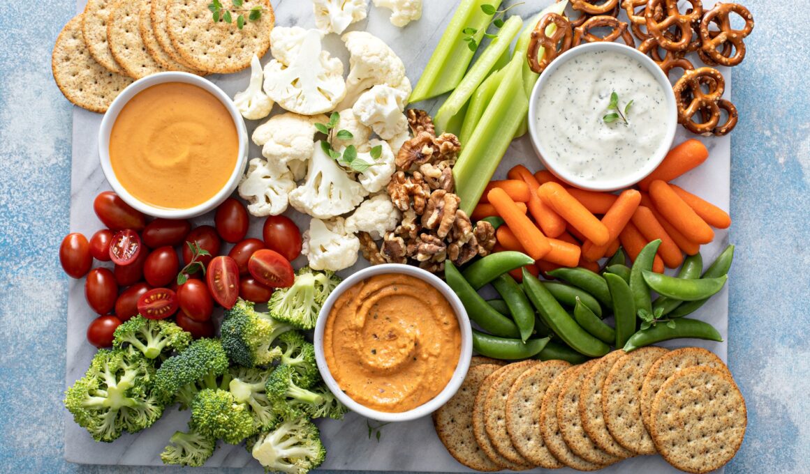 Plant based snack board with vegetables and crackers