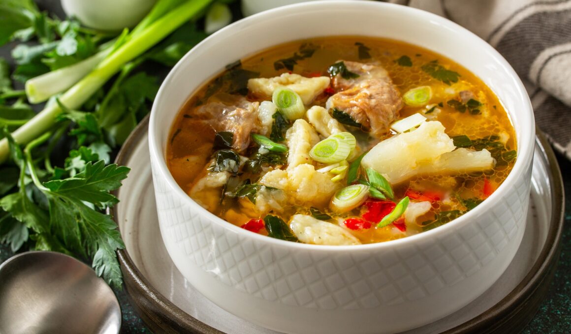 Hot delicious beef soup close-up. Homemade soup with meat, vegetables and gnocchi.