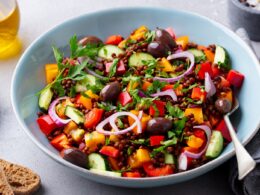 Lentil Salad with Mix Vegetables in bowl. Grey Background.