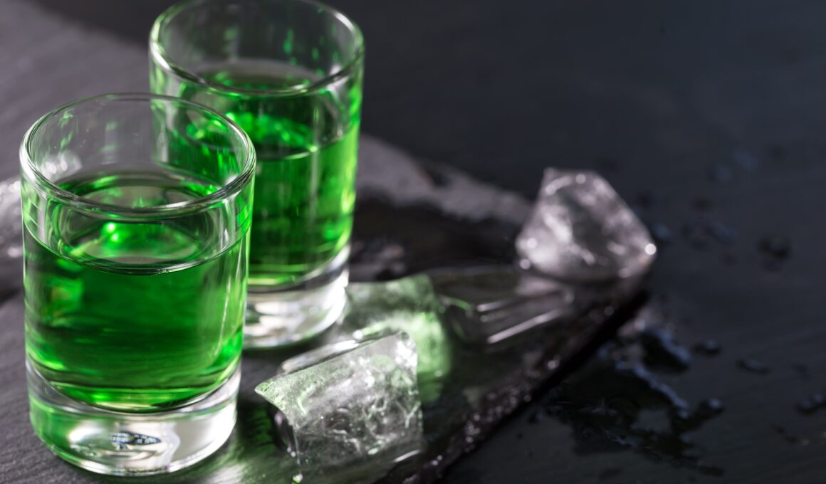 Two glasses of absinthe and melted ice cubes